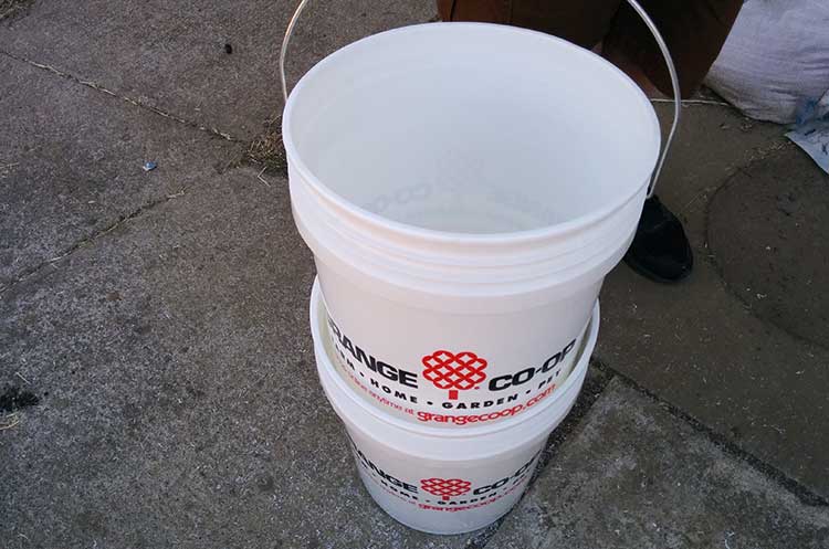 Placing bucket with drainage base in solid bucket