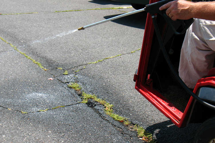 Spraying cracks in driveway