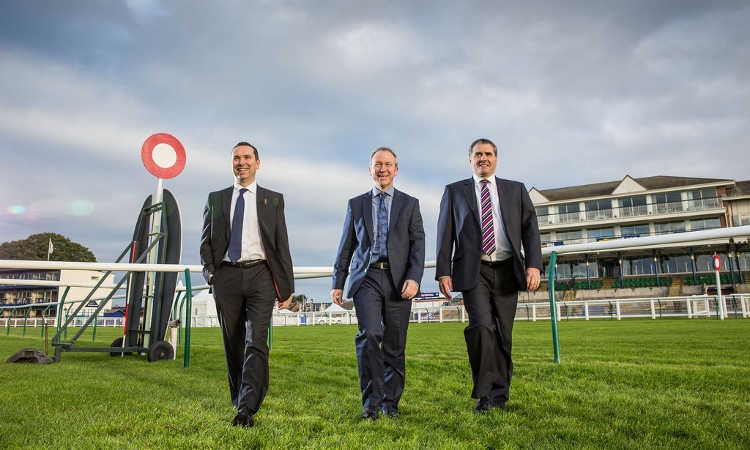 Business executives at racecourse